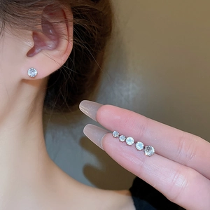 Macro view of five sizes of round cut cubic zirconia silver stud earrings for women
