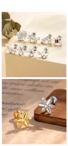 Macro detail of retro titanium steel screw-back earrings with floral and star designs