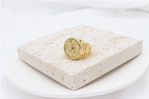 Macro detail of St. Michael golden signet ring with religious engraving on stone