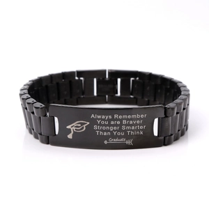 Detail of black stainless steel watch band bracelet with engraved graduation quote