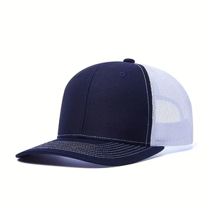 Detail view of navy blue and white mesh trucker hat with contrast stitching on the brim