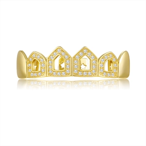 Detailed close-up of golden hip hop grillz with white zircon and star cutout