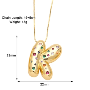 Detailed view of golden letter K necklace with colorful zircons and size measurements