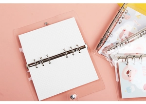 Detail of A6 transparent PVC binder with pink metal 6-ring clip and cartoon bear insert
