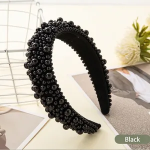 Retro black wide headband with layered faux pearls on a minimalist background