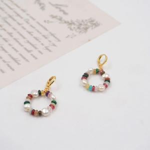 Colorful gemstone and pearl circle drop earrings with gold hoop on white background