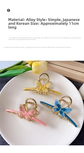 Detailed view of large alloy butterfly hair claws with metallic tassels in three colors