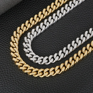 Close-up of gold and silver hip hop Cuban link chains with CNC rhinestones on black leather