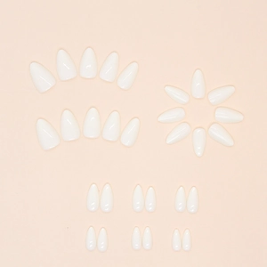 Glossy white almond-shaped press-on nails set arranged on a soft pink background