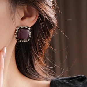 Retro square fabric stud earrings with red crystal and gold trim worn by a model