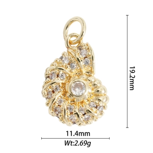 Macro detail of gold seashell pendant with clear crystals and dimensions 19.2x11.4mm