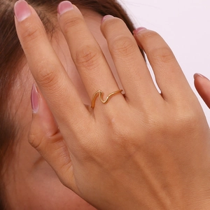Classic 18K gold plated stainless steel ring with wave design worn by a female model