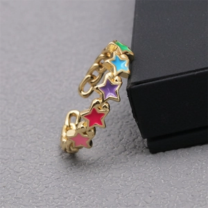 Detail of 18K gold ring with colorful enamel stars and micro-paved zircons