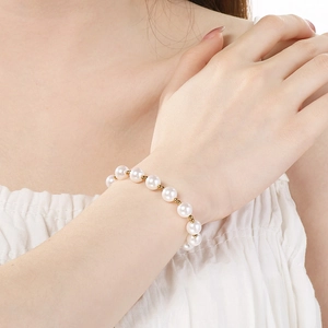 Close-up of elegant pearl bracelet with gold beads worn on a female wrist