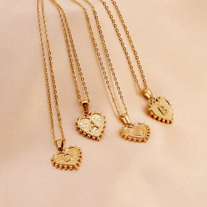 Golden titanium steel heart pendant necklace with hammered texture and engraved letters