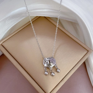 Close-up of titanium steel long-life lock necklace with Fu character and small bells