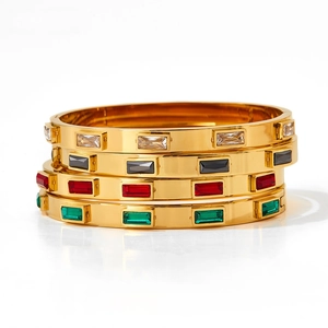 Detail view of gold stainless steel bangles with rectangular colorful zircon gemstones