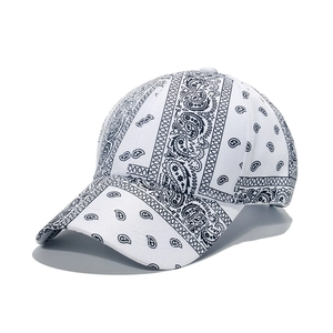 Detailed close-up of white paisley bandana baseball cap with black pattern and stitching