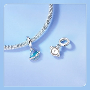 Macro detail of S925 sterling silver planet charm with blue gradient and star ring