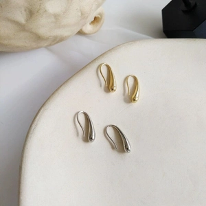 Minimalist stainless steel teardrop hook earrings in polished gold and silver finishes