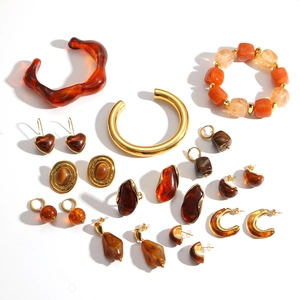 Amber resin and gold metal jewelry set featuring hoop earrings and beaded bracelets