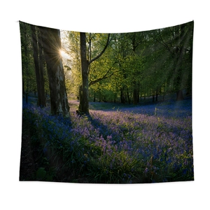Nordic wall hanging tapestry featuring sunlit forest with purple flowers landscape
