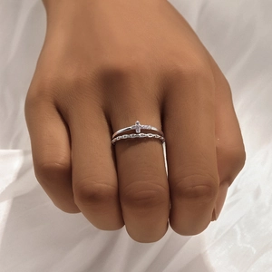 Detailed view of silver double-layered cross ring with zircon inlay on hand