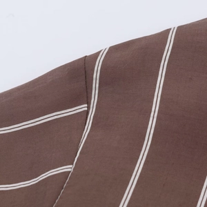 Close-up of brown and white vertical stripe shirt showing fine woven fabric texture