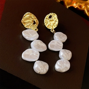 Elegant long faux pearl earrings with gold hammered metal finish on vintage wood