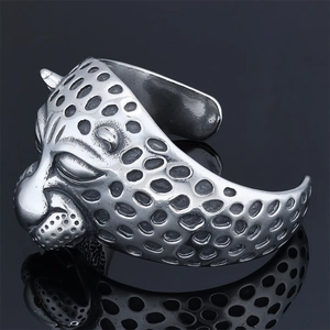 Detailed view of heavy stainless steel leopard head bracelet with antique silver finish