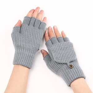 Macro shot of grey striped knitted gloves with fingerless flap and button detail