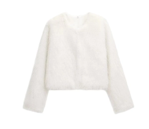 Detailed view of white faux fur jacket featuring plush texture and round neckline