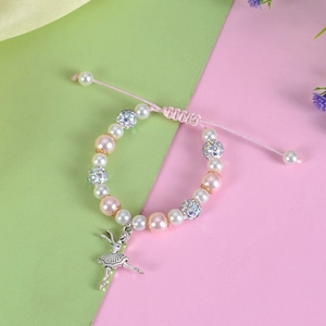 Detailed view of adjustable pearl bracelet with ballet girl pendant and crystal beads