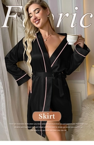 Detail of elegant black satin bathrobe with pink piping and silk-like fabric texture
