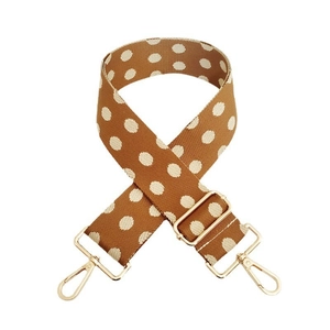 Detail of adjustable wide shoulder strap with brown and white polka dot pattern and gold hooks