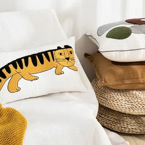 Modern white lumbar pillow with embroidered tiger pattern and geometric decorative cushions