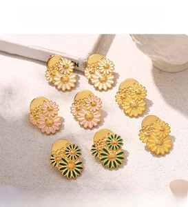 Detailed view of colorful enamel daisy stud earrings with electroplated PVD gold finish