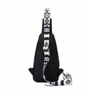 Detail of black crossbody bag with adjustable Aztec geometric pattern shoulder strap