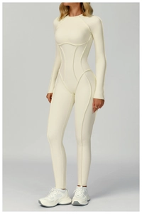 Full-body shot of a white long-sleeved yoga jumpsuit with structured stitching and sleek fit