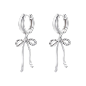 Macro detail of silver bow earrings with flowing tassel and sparkling zircon stones