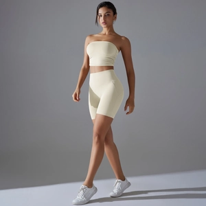 Close-up of beige two-piece seamless yoga set with tube top and high waist shorts
