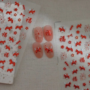 Red New Year nail stickers with traditional Chinese zodiac motifs and festive floral designs