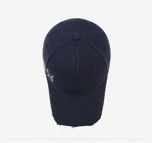 Detail of navy cotton baseball cap with white KS embroidery and distressed brim details