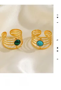 Detail of gold bead rings featuring malachite and turquoise stones on silk fabric