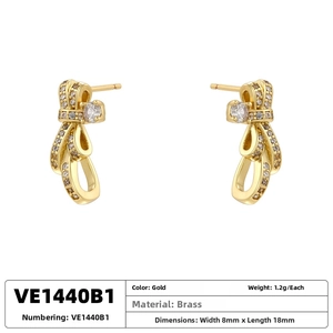 Detailed view of elegant gold bow earrings with brass and cubic zirconia dimensions