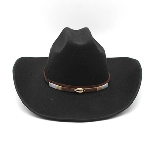 Detail of black felt cowboy hat with colorful woven band and golden shell ornament