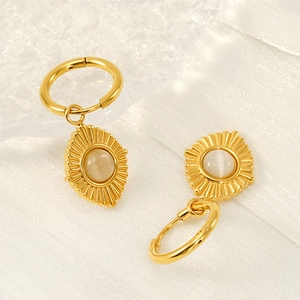 18K gold plated stainless steel hoop earrings with white cat eye stone on silk background