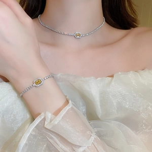Detail of silver choker and bracelet set with square yellow zircon and micro-pave crystals