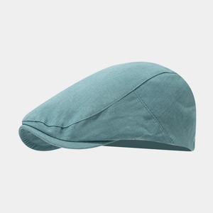 Detail view of the stitching and twill cotton texture on a classic teal flat cap