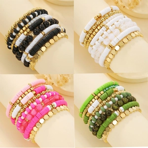Handmade clay heishi bead bracelets set in multi-color layers with gold metal accents